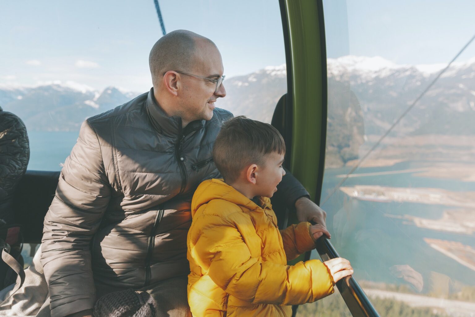 Father and son in the gondola of a cable car, Squamish, Canada